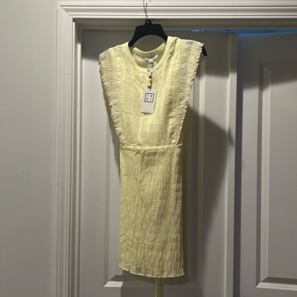 Light yellow dress with front buttons and belt.